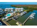 Picturesque aerial view of condo community with pool, boat docks, and waterfront access at 2424 Placida Rd # D102, Englewood, FL 34224
