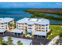 Exterior view of condo complex with covered parking and waterfront scenery at 2424 Placida Rd # D102, Englewood, FL 34224