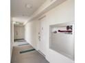 Hallway with carpeted floors, white walls and doors, including visible utility equipment at 2425 Gulf Of Mexico Dr # 14B, Longboat Key, FL 34228