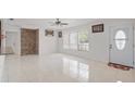 Bright living room with tile flooring, ceiling fan, and neutral paint at 2524 Tuttle Way, Sarasota, FL 34239