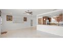 Open-concept living area with tile flooring, and direct views into the kitchen at 2524 Tuttle Way, Sarasota, FL 34239