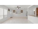 Bright living room with tile flooring, ceiling fan, and neutral paint at 2524 Tuttle Way, Sarasota, FL 34239