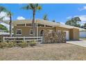 Charming single-story home features a unique stone accent wall, white fence, and a well-maintained yard at 2820 Greenbriar St, Sarasota, FL 34237
