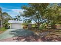 Charming single-story home with a well-maintained lawn, mature trees, and a driveway at 335 Arthur Dr, Sarasota, FL 34236