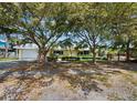 Charming single-story home with mature trees, attached garage, and a well-manicured lawn at 335 Arthur Dr, Sarasota, FL 34236