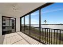 Enclosed balcony with tile floor, ceiling fan, and beautiful water views at 3630 Gulf Of Mexico Dr # 202, Longboat Key, FL 34228