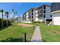 Condo complex with well-manicured lawns and sidewalks at 3630 Gulf Of Mexico Dr # 202, Longboat Key, FL 34228