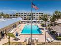 Community pool with ample seating, lounge chairs, and clubhouse amenities for residents to enjoy at 3806 Gulf Of Mexico Dr # C204, Longboat Key, FL 34228
