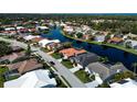 Expansive community aerial view showcasing homes bordering a beautiful lake at 4257 Hearthstone Dr, Sarasota, FL 34238