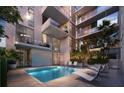 Relaxing pool area with lounge chairs and lush landscaping offering a serene retreat at 430 Kumquat Ct # 410, Sarasota, FL 34236