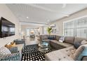 Spacious living room with a comfortable gray sectional, patterned rug, and open floor plan at 4321 Marina View Way, Cortez, FL 34215