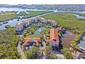 Aerial view of complex showing pond, tennis courts, and proximity to the waterway at 5450 Eagles Point Cir # 404, Sarasota, FL 34231