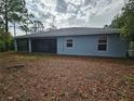 View of the back exterior of the house, featuring a screened in back porch in a large back yard at 5849 Wagon Wheel Dr, North Port, FL 34291