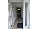 Inviting front entry displaying pristine hardwood floors and a stylish chandelier at 5849 Wagon Wheel Dr, North Port, FL 34291