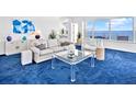 Cozy living room with a view of the ocean and a white couch at 601 Longboat Club Rd # 504S, Longboat Key, FL 34228