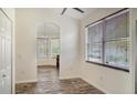 Bright office space with wooden flooring, large windows, and an arched doorway at 6213 Willet Ct, Lakewood Ranch, FL 34202