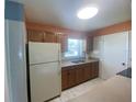 Bright kitchen features wood cabinets and tile flooring at 6618 Kenwood Dr, North Port, FL 34287