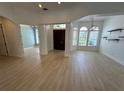 Open foyer featuring wood flooring, arched doorways and windows, and a decorative chandelier at 6839 Turnberry Isle Ct, Lakewood Ranch, FL 34202