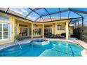 An inviting screened-in pool area with a spa and lounge chairs, perfect for outdoor relaxation and entertainment at 7081 Grassland Ct, Sarasota, FL 34241