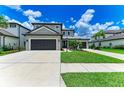 Stunning two-story home with a spacious three-car driveway and well-kept lawn at 8264 Summer Night Rd, Sarasota, FL 34241