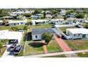 An aerial view of a cozy single-story home showcasing the property's layout within a quiet residential neighborhood at 8725 Aero Ave, North Port, FL 34287