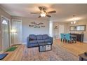Inviting living room with a comfortable sofa, modern ceiling fan, and stylish decor, creating a cozy atmosphere at 8725 Aero Ave, North Port, FL 34287