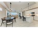 Open-concept living space showcasing modern finishes, a kitchen island, dining area, and seamless flow at 909 Crosswind Ave, Sarasota, FL 34240