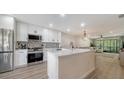 Modern kitchen with white cabinets, stainless steel appliances, and stylish backsplash at 946 N Beneva Rd # V26, Sarasota, FL 34232