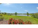 Expansive backyard view with a picturesque lake and lush landscaping, creating a serene setting at 12708 Aquamarine Ave, Bradenton, FL 34211