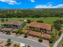 Stunning aerial view of the condos nestled in a lush, green landscape next to a golf course with verdant trees at 13810 Messina Loop # 202, Bradenton, FL 34211