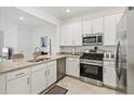 A bright, modern kitchen featuring granite countertops and stainless steel appliances at 14835 Lyla Ter, Bradenton, FL 34211