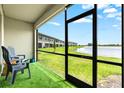A cozy screened-in lanai with a view of the serene lake at 14835 Lyla Ter, Bradenton, FL 34211
