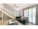 Bright living room featuring neutral walls, a ceiling fan, and an inviting seating arrangement at 2420 Webber St, Sarasota, FL 34239