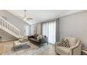 A well-lit living room with a comfy sofa, chair, and elegant decor for relaxation and entertainment at 2420 Webber St, Sarasota, FL 34239