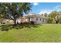 Exterior view of the house showcasing the well-maintained lawn and lush landscaping at 2662 6Th E Ct, Ellenton, FL 34222