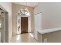 Bright foyer with tile flooring, high ceilings, and a decorative front door at 2662 6Th E Ct, Ellenton, FL 34222