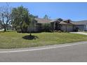 Well maintained one story home with lush green lawn and mature trees and landscaping at 3110 57Th Avenue E Cir, Bradenton, FL 34203