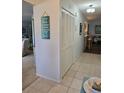 Hallway with closet and views of dining room with tile flooring at 3110 57Th Avenue E Cir, Bradenton, FL 34203