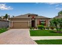 Attractive single-story home features lush lawn, brick driveway, and vibrant landscaping at 3712 76Th E St, Palmetto, FL 34221