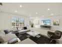 Modern living room with a sectional sofa, large windows, and stylish decor at 386 Club Manor Dr, Sun City Center, FL 33573
