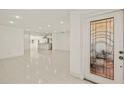 Spacious open floorplan showcasing tile floors with a view to the kitchen at 386 Club Manor Dr, Sun City Center, FL 33573