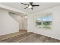 Bright living room with wood-look flooring and a large window that floods the space with natural light at 4005 Willow Branch Pl, Palmetto, FL 34221