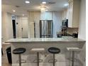 Modern kitchen features stainless steel appliances and a breakfast bar with seating at 4441 Groveland Ave, Sarasota, FL 34231