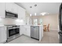 Modern kitchen featuring stainless steel appliances, quartz countertops, and white cabinets at 4472 Calle Serena, Sarasota, FL 34238