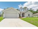 This home features a well-maintained lawn, two-car garage, and a cozy, inviting entrance at 4610 Clarke St, North Port, FL 34286