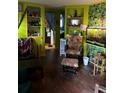 Eclectic living room featuring bright green walls, unique shelving, and comfortable seating at 5011 Elfrida Ave, Sarasota, FL 34235