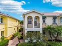 Inviting home exterior with double balconies, arched windows, and well-maintained landscaping at 5368 Eliseo St, Sarasota, FL 34238