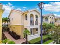 Charming two-story home with a balcony, manicured landscaping and a brick walkway at 5368 Eliseo St, Sarasota, FL 34238