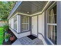 Inviting front entrance with stylish gray trim and a tiled porch at 5508 83Rd E Ter, Sarasota, FL 34243