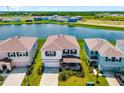 Aerial view of a lakeside home with lush green surroundings in a peaceful neighborhood at 5644 Flagstone Trl, Palmetto, FL 34221